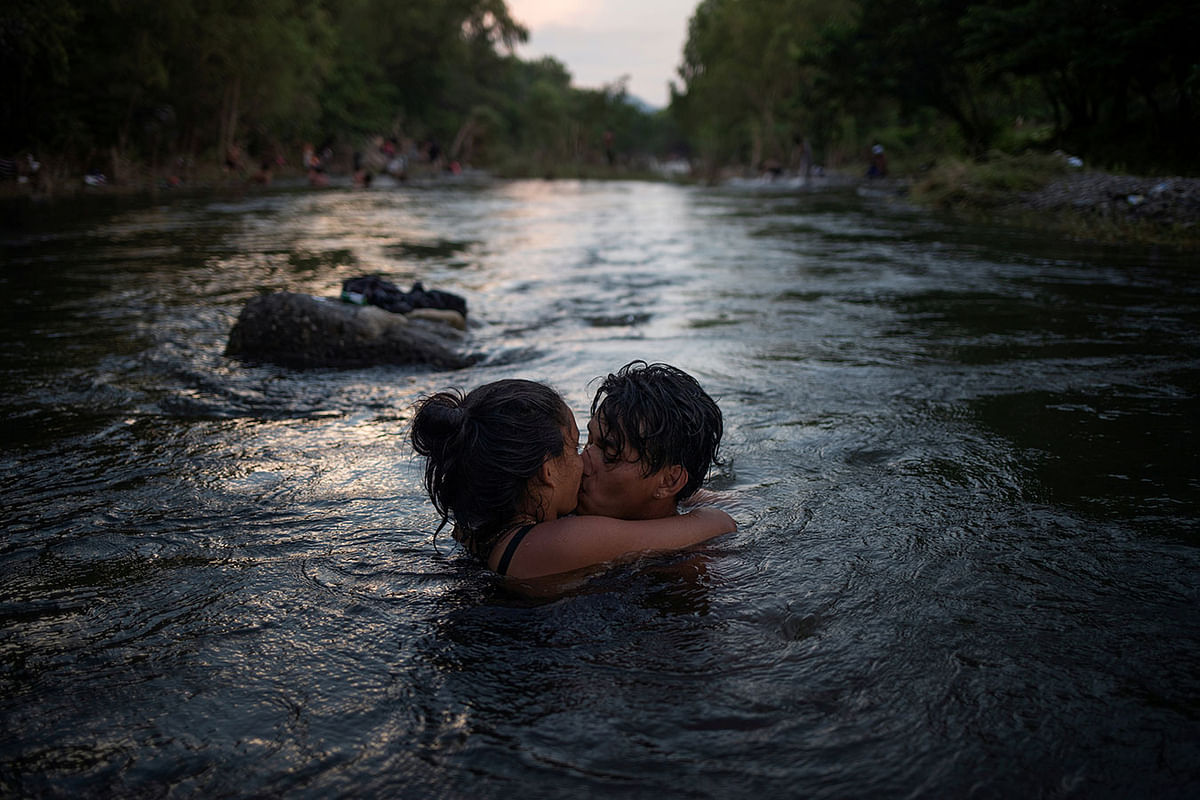 Israel and Estelle, both from Honduras, part of a caravan of thousands of migrants from Central America en route to the United States, kiss while bathing in Rio Novillero in San Pedro Tapanatepec, Mexico, 27 October 2018. Photo: Reuters