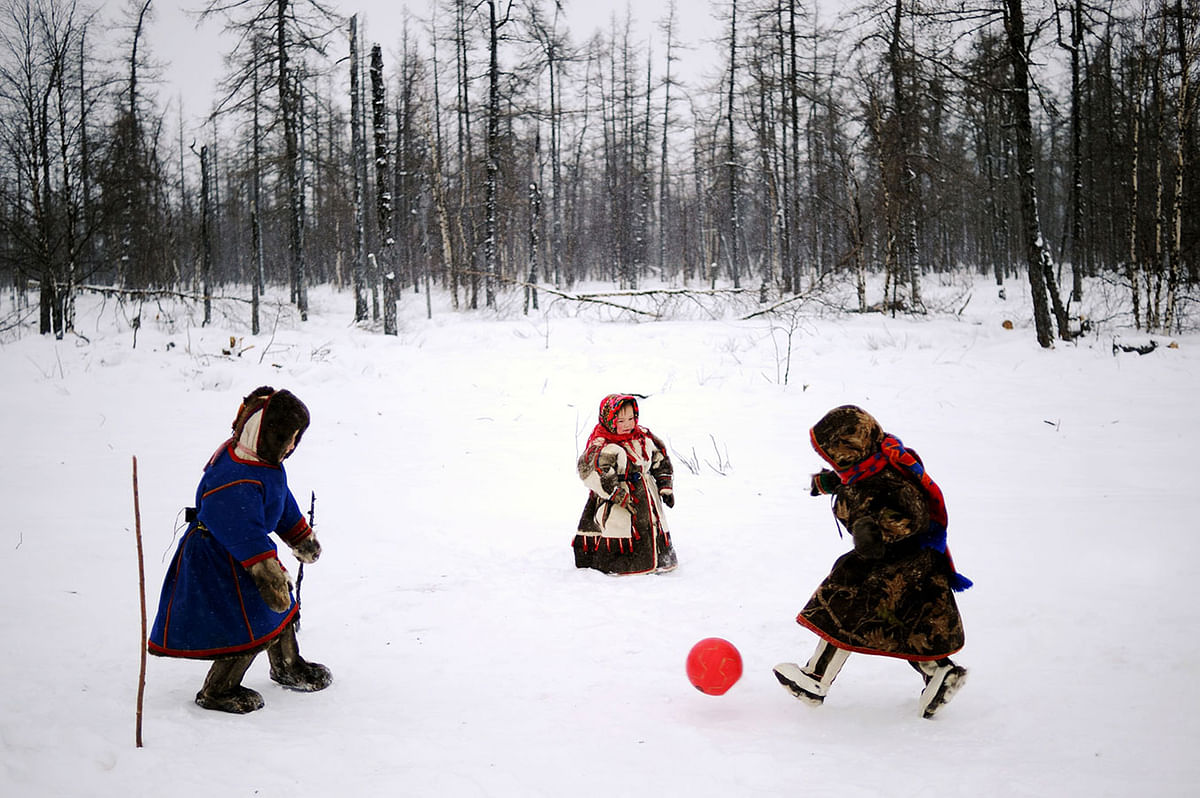 Children of reindeer herders play with a ball on the snow in the remote Yamalo-Nenets region of northern Russia on 6 March 2018. Photo: AFP