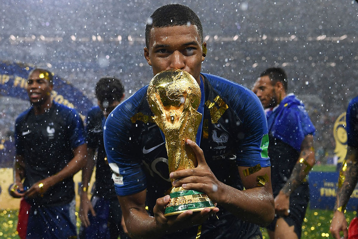 France`s forward Kylian Mbappe kisses the World Cup trophy after winning the Russia 2018 World Cup final football match between France and Croatia at the Luzhniki Stadium in Moscow on 15 July 2018. Photo: AFP