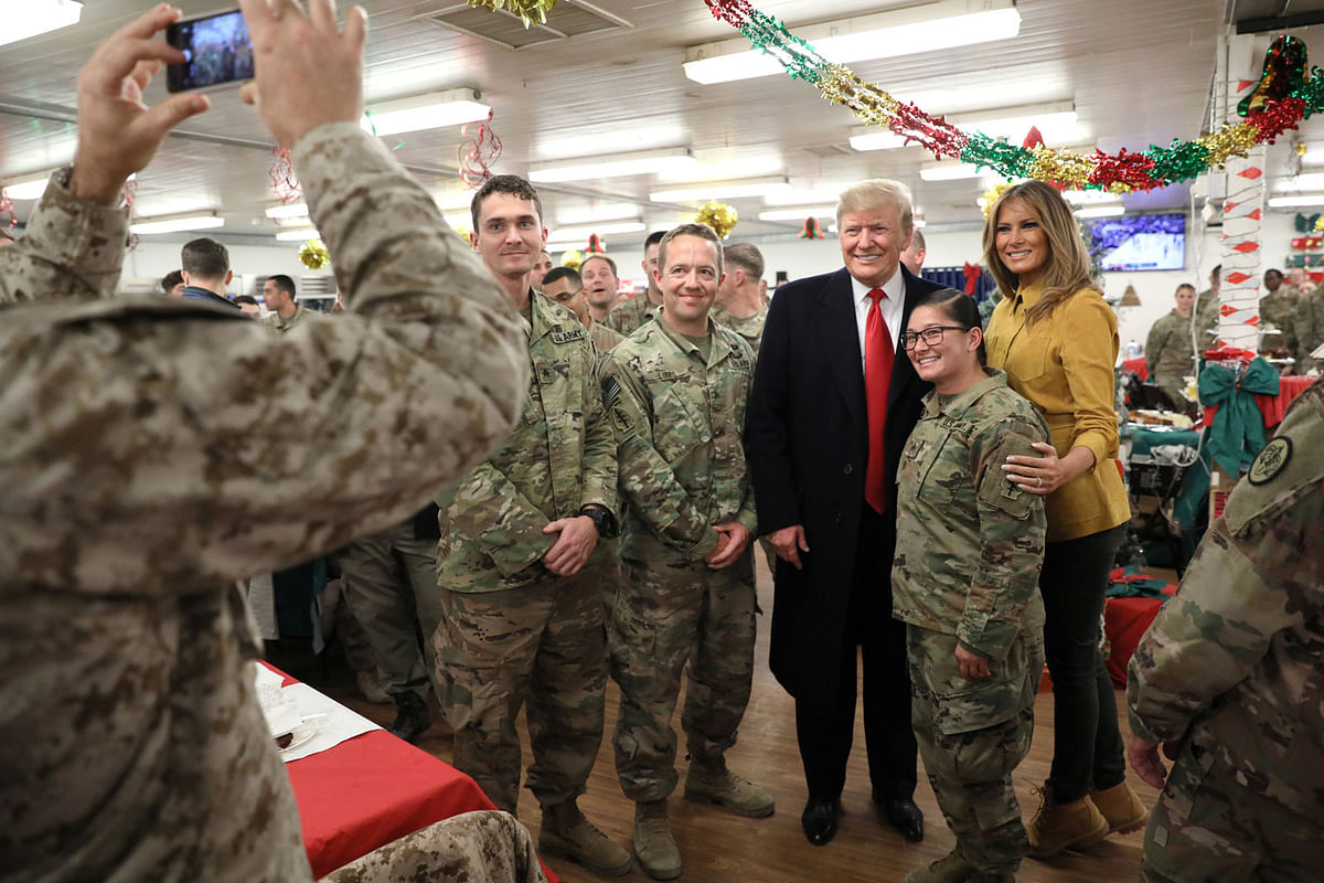 US president Donald Trump and First Lady Melania Trump greet military personnel at the dining facility during an unannounced visit to Al Asad Air Base, Iraq on 26 December 2018. Photo: Reuters