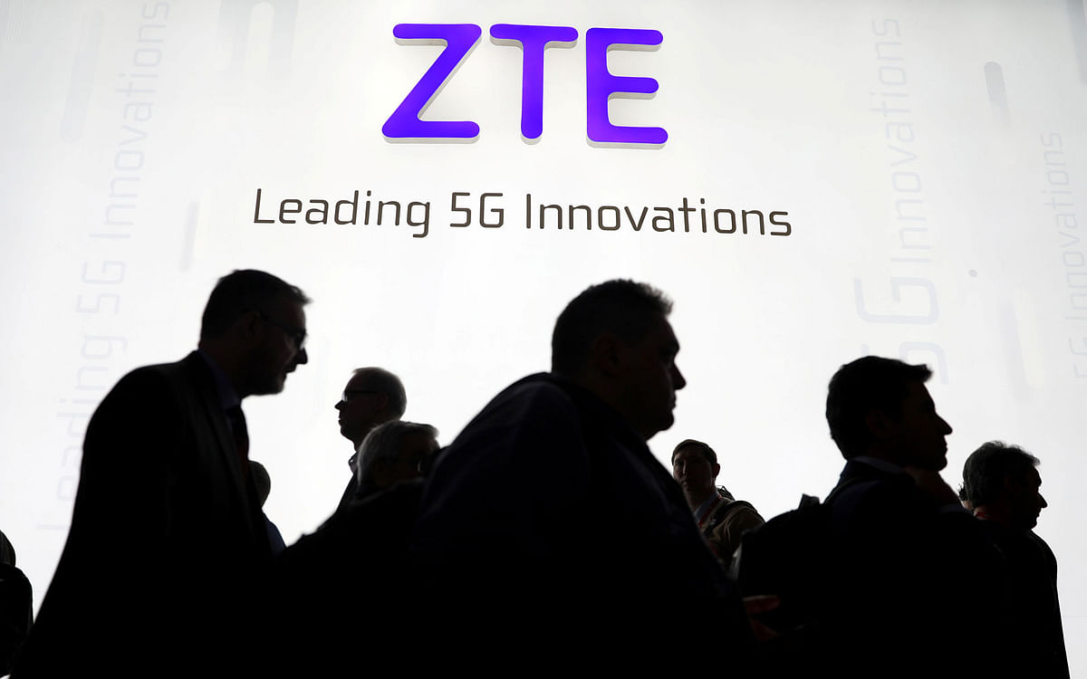 Visitors pass in front of the Chinese telecoms equipment group ZTE Corp booth at the Mobile World Congress in Barcelona, Spain on 26 February. Photo: Reuters