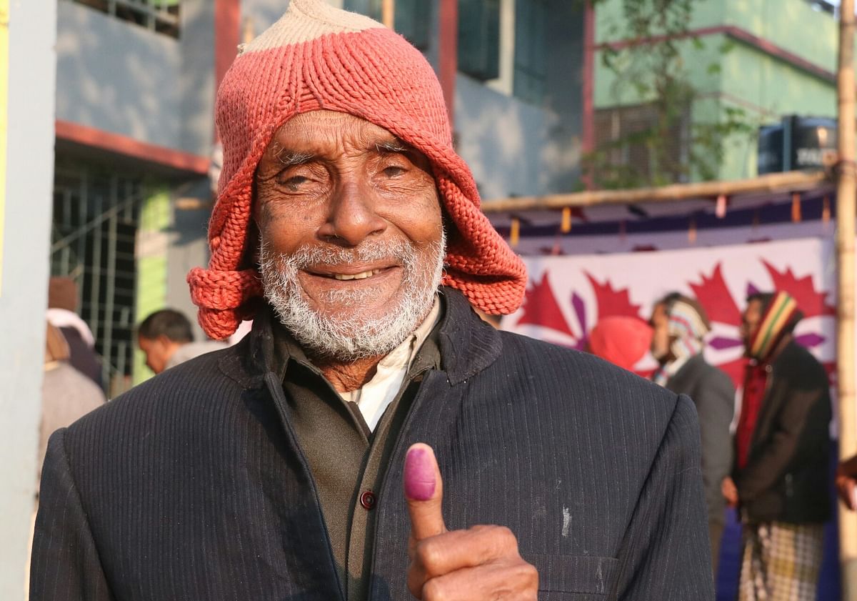 Taijul Islam showing his marked thumb after casting vote at Shiroil Colony Government Primary School in ajshahi on 30 December. The 78-year old man was the first voter in this centre to cast vote. Photo: Shahidul Islam