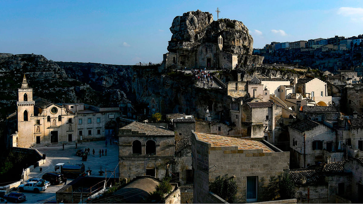 This file photo taken on 19 October 2018 shows visitors walking towards the cave church Madonna de Idris (Rear C) in the southern Italian city of Matera, which has been selected as the 2019 European capital of culture. Photo: AFP