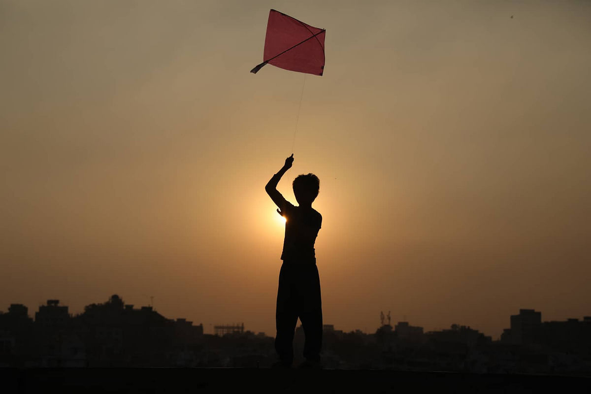 A child flies kite during sunset at Faridabad, Dhaka on 31 December 2018. Photo: Dipu Malakar
