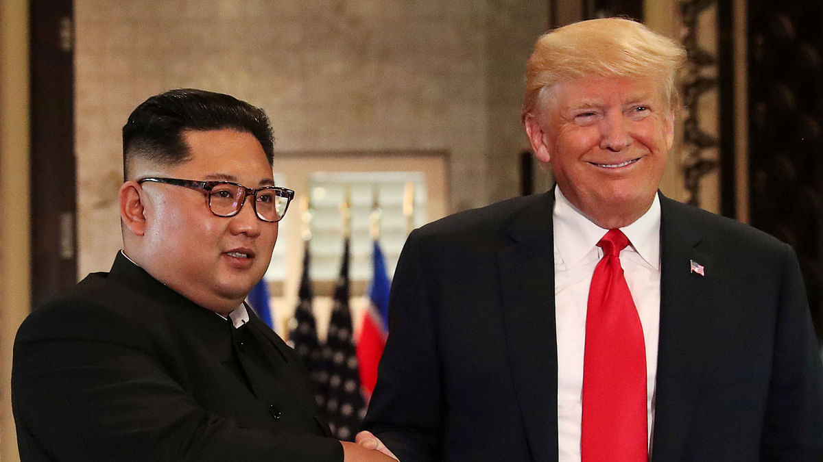 US president Donald Trump and North Korea`s leader Kim Jong Un shake hands after signing documents during a summit at the Capella Hotel on the resort island of Sentosa, Singapore on 12 June 2018. Photo: Reuters