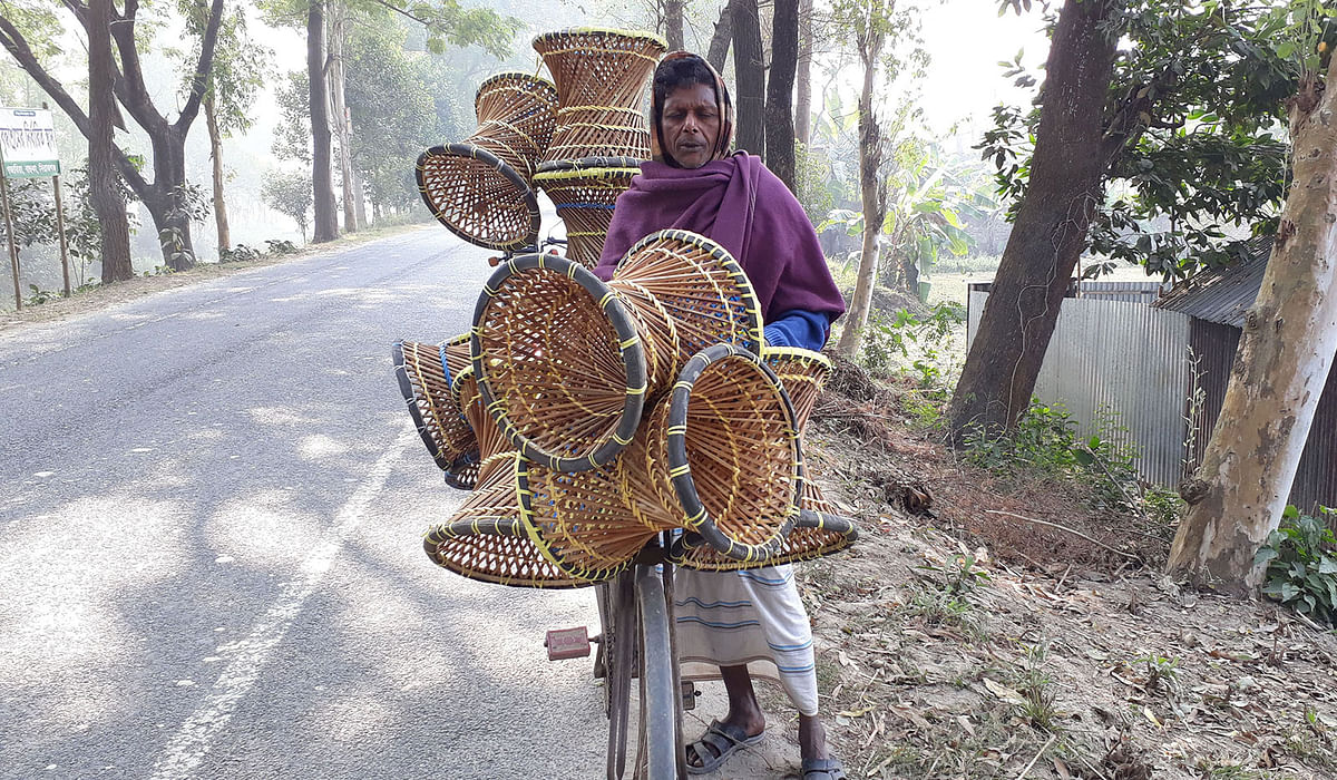 A man selling stools made of canes along the Sirajganj-Kazipur Road in Chilgachha, Raiganj, Sirajganj on 2 Januray. Photo: Sajedul Alam