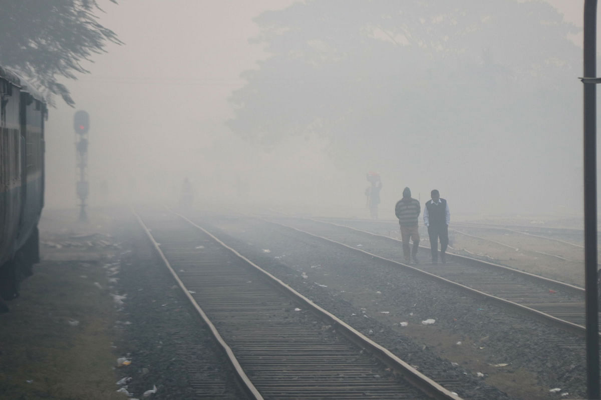 People are seen walking in a foggy morning as mercury dips in Ishwardi, Pabna on 4 January. Photo: Hasan Mahmud
