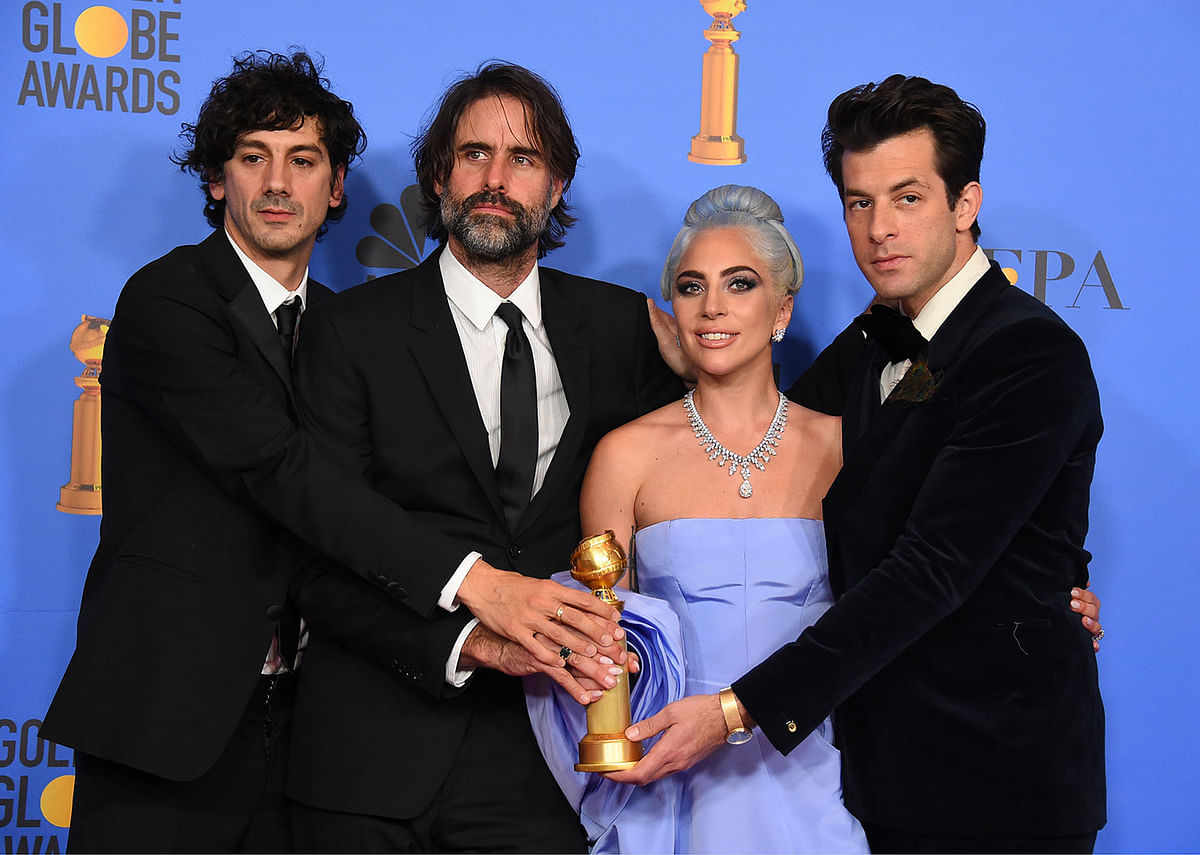 Anthony Rossomando, from left, Andrew Wyatt, Lady Gaga and Mark Ronson pose in the press room with the award for best original song, motion picture for `Shallow` from the film `A Star Is Born` at the 76th annual Golden Globe Awards. Photo: AP