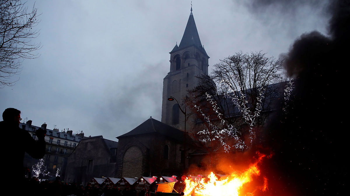 Fire is seen near a Christmas market during a demonstration by the “yellow vests” movement at Boulevard Saint Germain in Paris, France on 5 January. Reuters File Photo