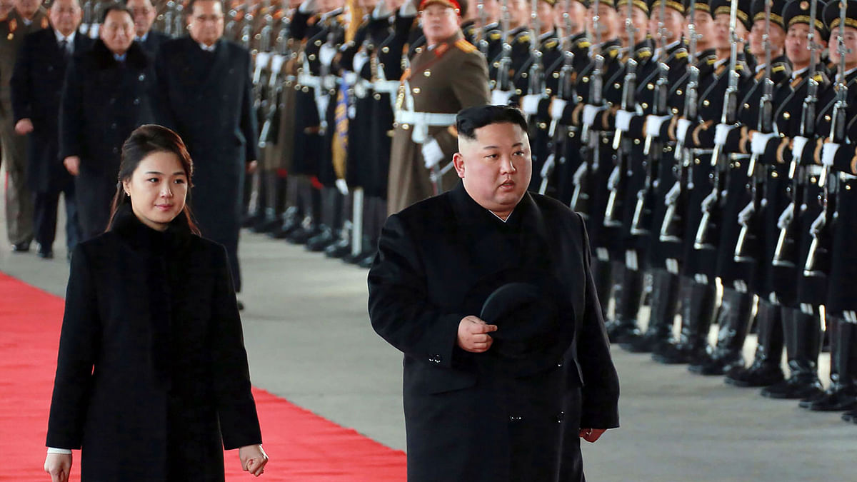 This picture taken on 7 January and released by North Korea’s official Korean Central News Agency (KCNA) on 8 January shows North Korean leader Kim Jong Un ® and his wife Ri Sol Ju leaving Pyongyang Station to visit China. Photo: AFP