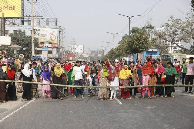 Agitating RMG workers are seen chanting slogans blocking road in Savar on Wednesday. Photo: Suvra Kanti Das