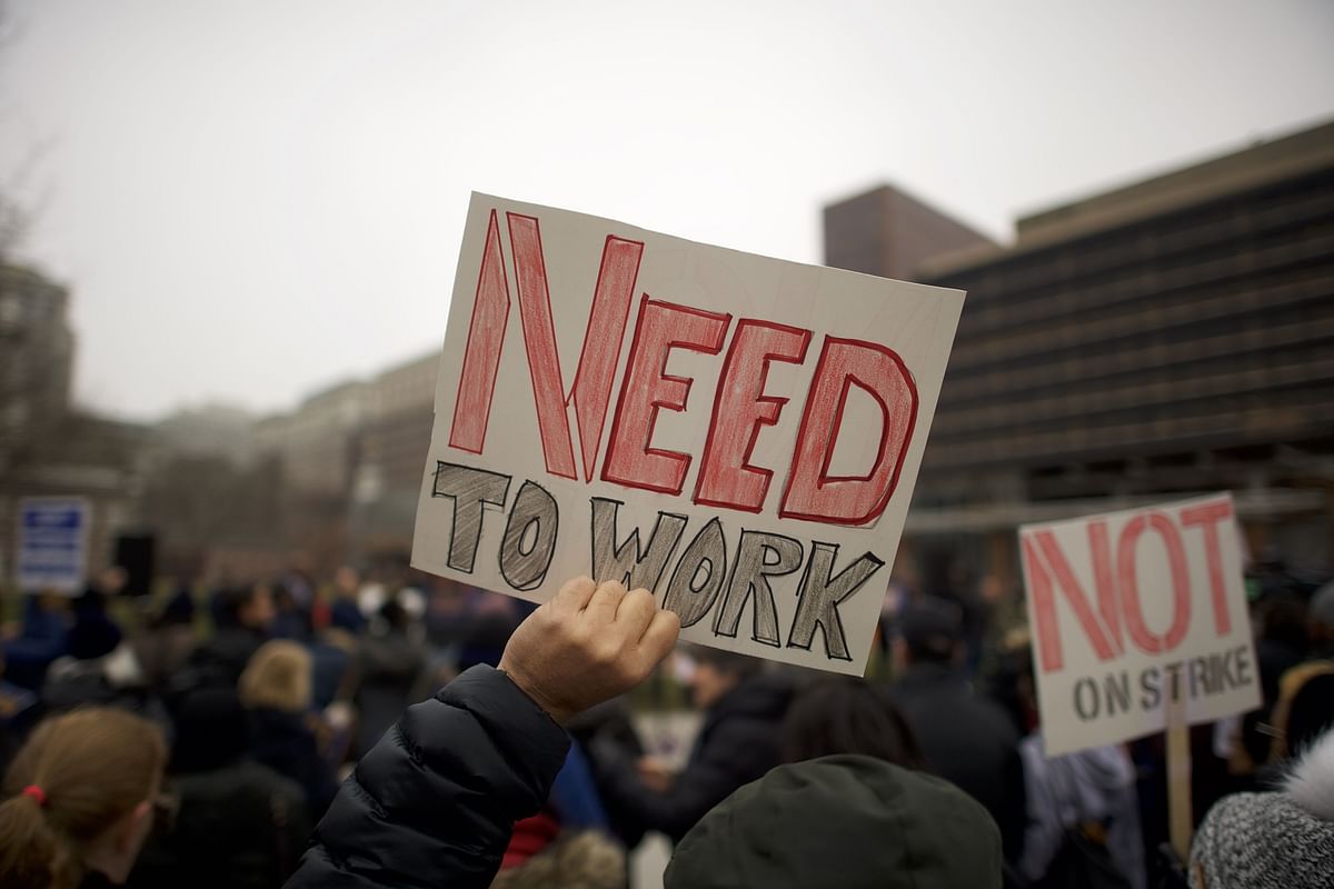 Fred Jennings, 67, holds a placard stating `NEED TO WORK` while gathering with area elected officials and furloughed federal workers at a rally in front of Independence Hall on 8 January 2019 in Philadelphia, Pennsylvania. Photo: AFP