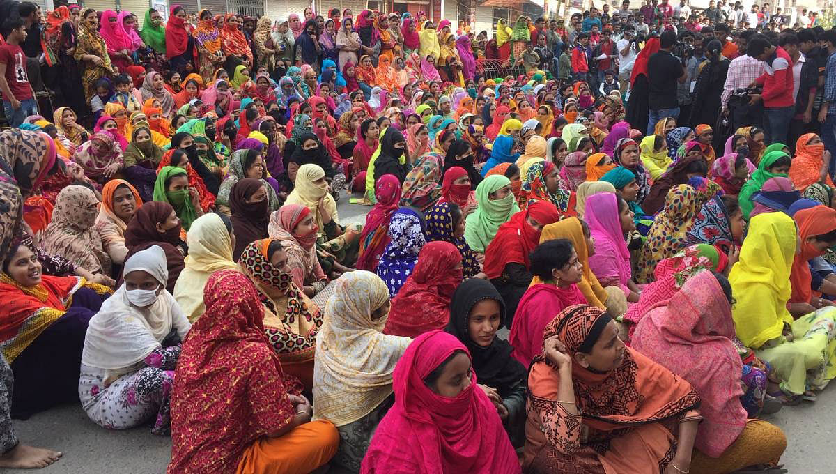 Readymade garment workers hold a demonstration organised in Savar for the fourth consecutive day on Wednesday demanding implementation of minimum wage structure. Photo: UNB