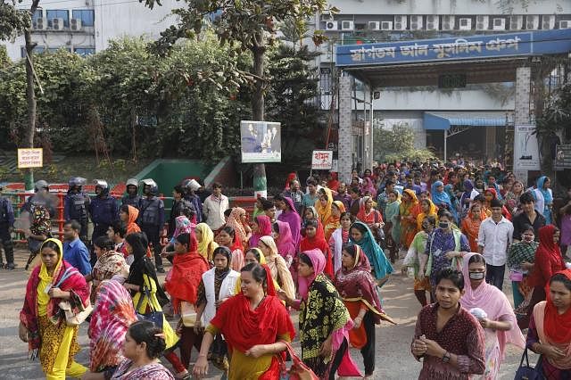Agitating RMG workers are seen in front of a factory in Savar on Wednesday. Photo: Suvra Kanti Das