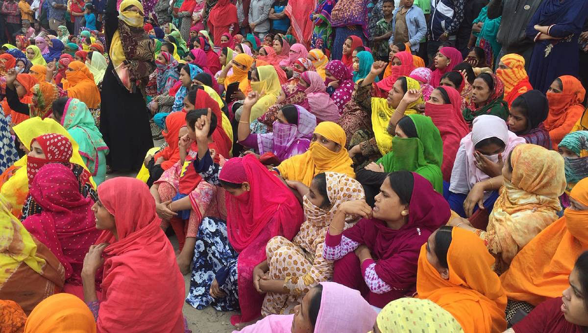 Readymade garment workers hold a demonstration organised in Savar for the fourth consecutive day on Wednesday demanding implementation of minimum wage structure. Photo: UNB