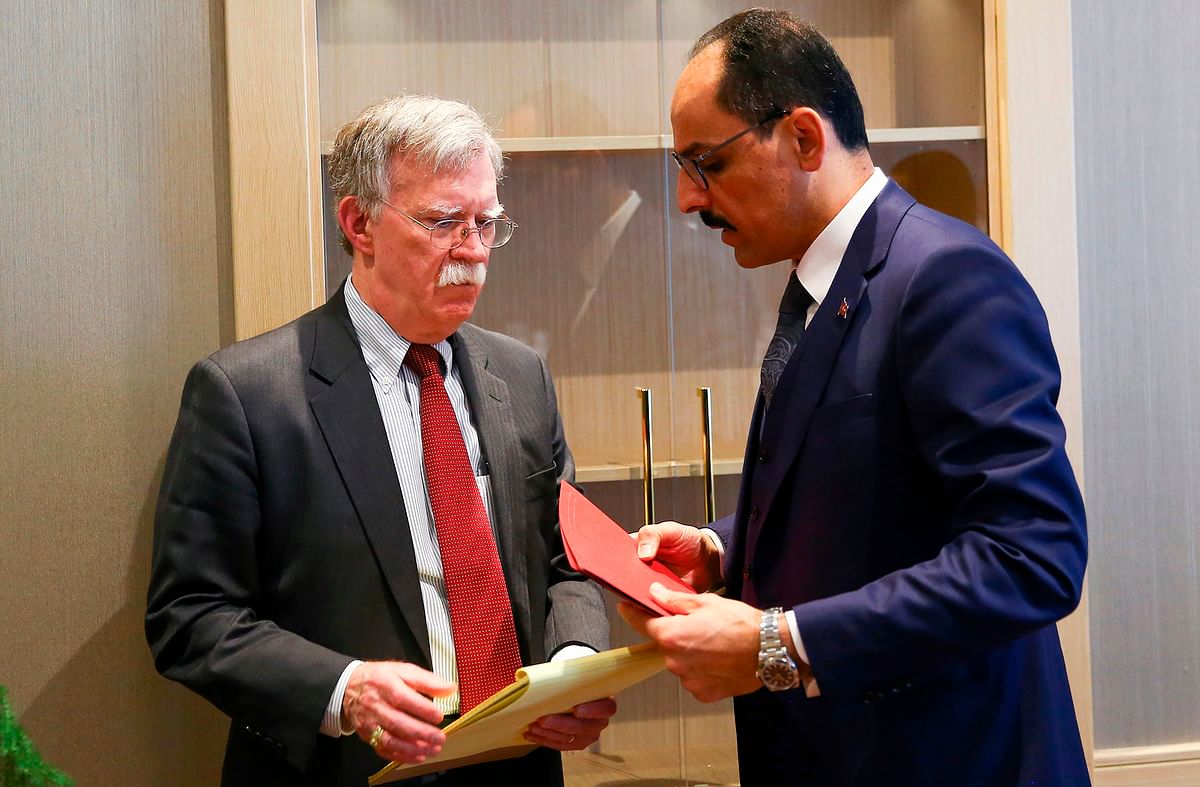This handout photo shows Turkish presidential spokesman Ibrahim Kalin (R) speaking with US National Security adviser John Bolton following their meeting at the presidential complex in the capital Ankara, on 8 January. Photo: AFP