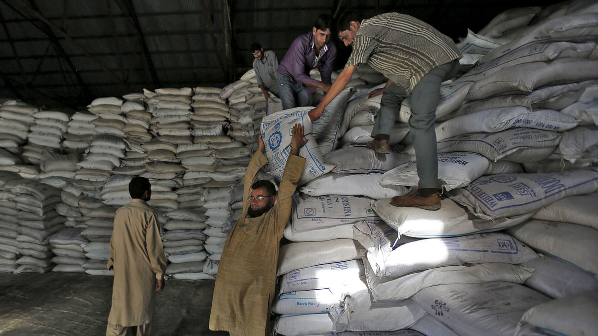 A Kashmiri labourer prepares to carry a sack containing sugar inside a government warehouse in Srinagar, on 4 August 2015. Reuters File Photo