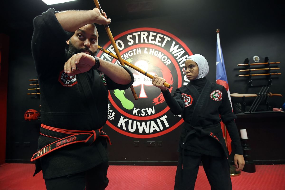 Kuwaiti Faisal al-Gharib (L), a Kajukenbo hybrid martial art master, practises with his assistant Fai al-Fahad , in a club in Kuwait City on 22 October 2018. Photo: AFP