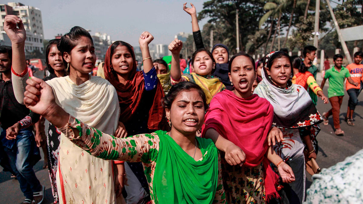 In this file photo taken on 8 January 2019 Bangladeshi striking garments workers march in the streets to demand wage hikes in Dhaka. Photo: AFP