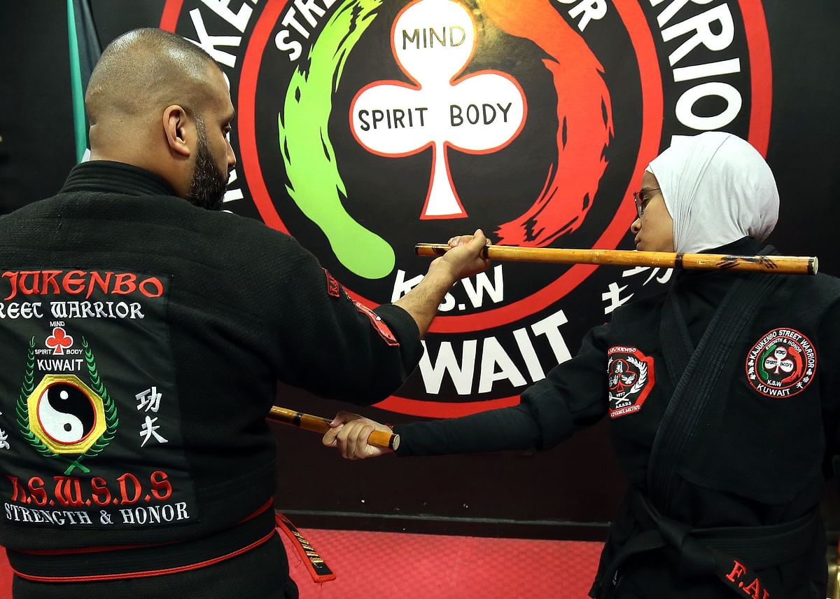 Kuwaiti Faisal al-Ghareeb (L), a Kajukenbo hybrid martial art master, practises with his assistant Fai al-Fahad , in a club in Kuwait City on 22 October 2018. Photo: AFP