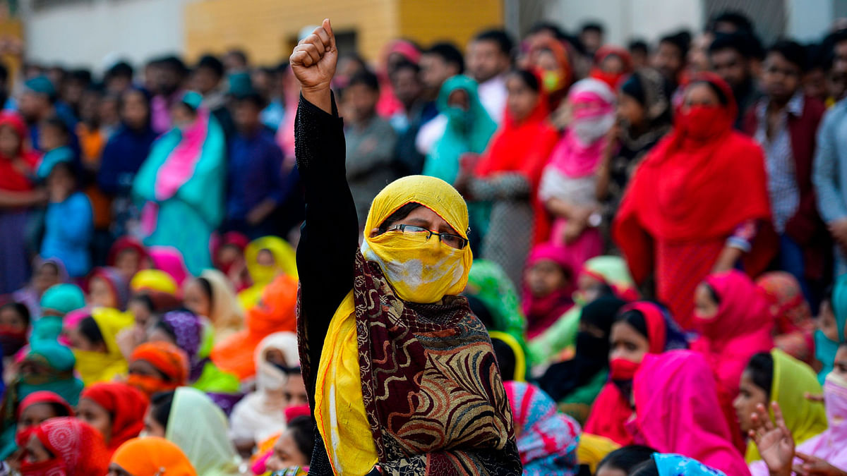 A Bangladeshi garment worker shouts slogans as they block a road during a demonstration to demand higher wages, in Dhaka on 9 January 2019. AFP File Photo