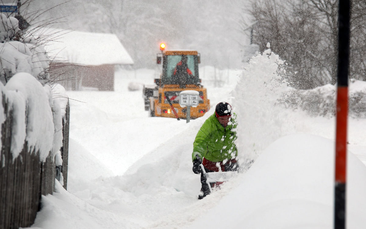 A man uses a snow blower after heavy snowfalls near Irschenberg, southern Germany on 10 January. Photo: Reuters