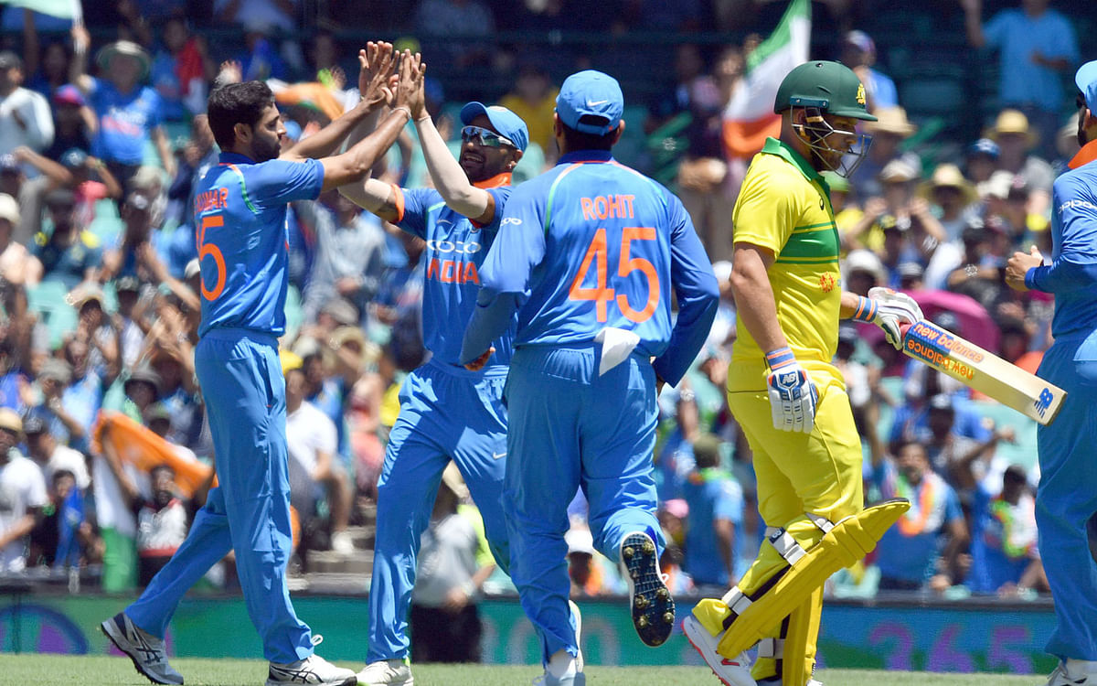 India’s paceman Bhuvneshwar Kumar celebrates dismissing Australia’s Aaron Finch ® with teammates during the first one-day International (ODI) match at the Sydney Cricket Ground in Sydney on 12 January 2019. Photo: AFP