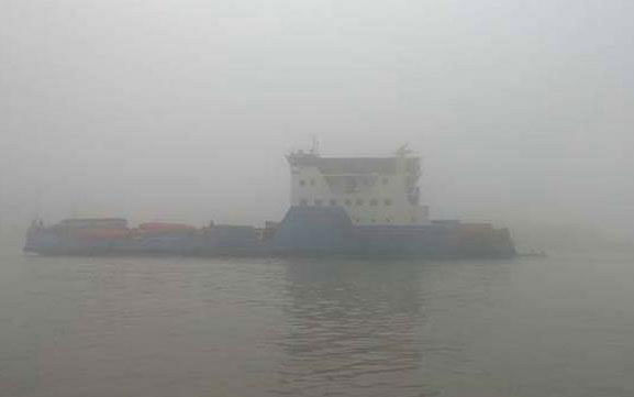 A ferry is seen across dense fog. Photo: UNB