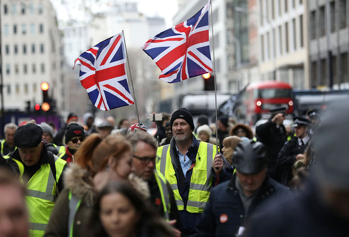 A protester holds British union flags before a pro-Brexit demonstration march in central London, Britain on 12 January 2019. Photo: Reuters