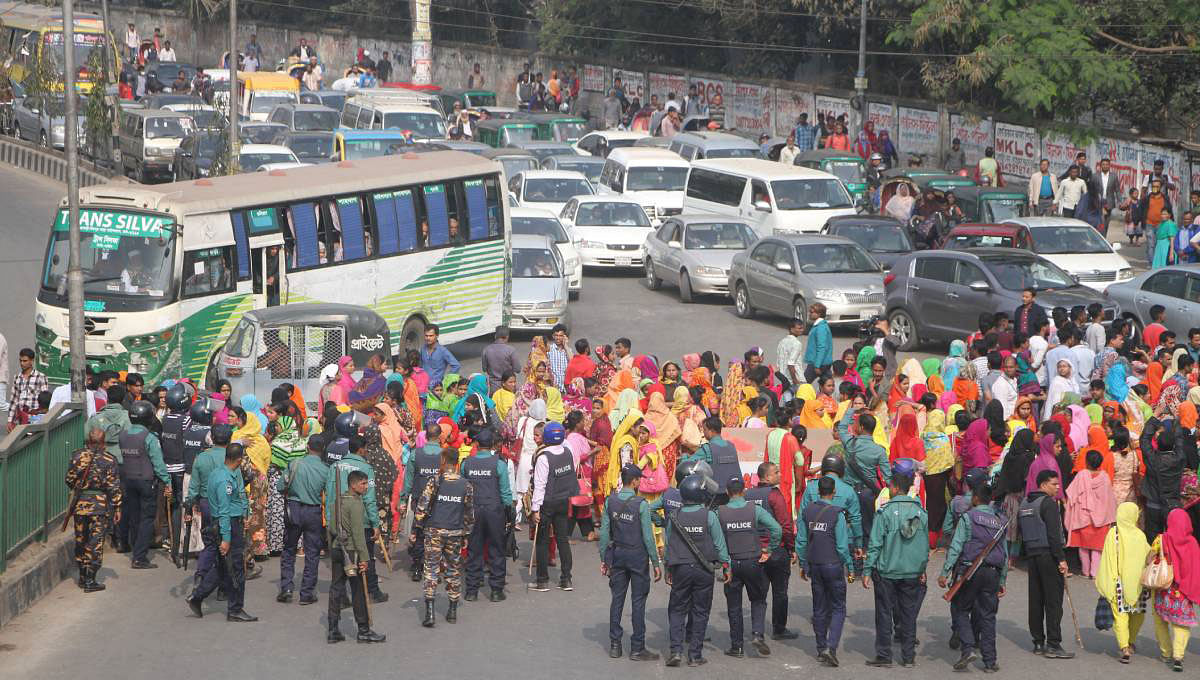 Garment workers block road during a protest on Saturday. Photo: UNB