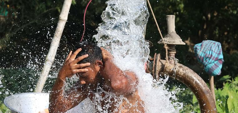 A farmer bathing in deep tubewell water in Brahmanpara, Cumilla