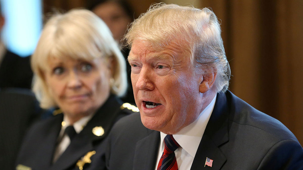 US president Donald Trump speaks while Chester County, Pennsylvania sheriff Bunny Welsh listens as the president hosts a `roundtable discussion on border security and safe communities` with state, local, and community leaders in the Cabinet Room of the White House in Washington, US on 11 January. Photo: Reuters