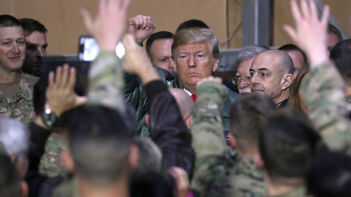 US president Donald Trump delivers remarks to US troops in an unannounced visit to Al Asad Air Base, Iraq on 26 December 2018. Photo: Reuters