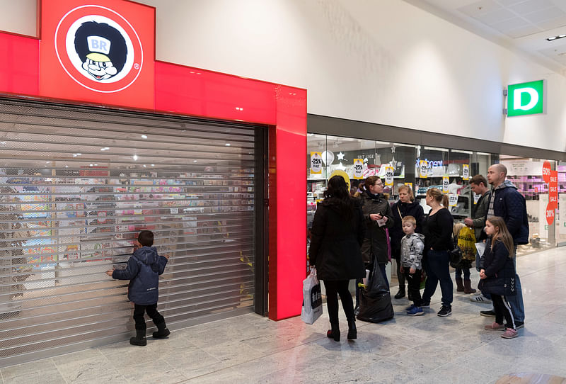 Children are with their parents at a Faetter BR store is seen at Roskilde Torv in Roskilde. Photo: Reuters