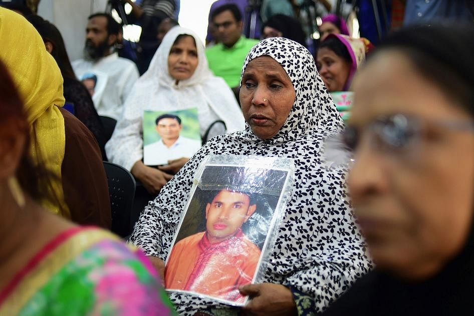 Women hold photos of missing relatives during a press meeting in Dhaka on 4 December, 2018. Hundreds joined in the protest demanding justice for the victims. Photo: AFP