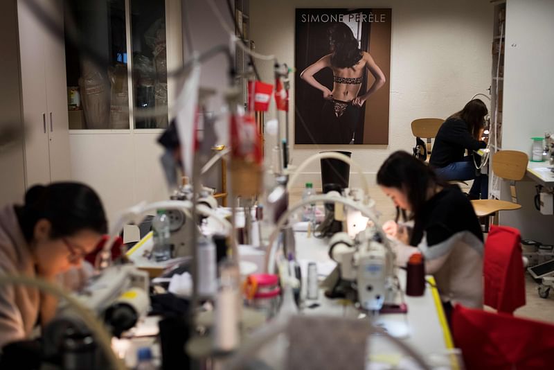 Seamstresses work at the Simone Perele lingerie company headquarters in Clichy, outside Paris, on 20 December 2018. Photo: AFP