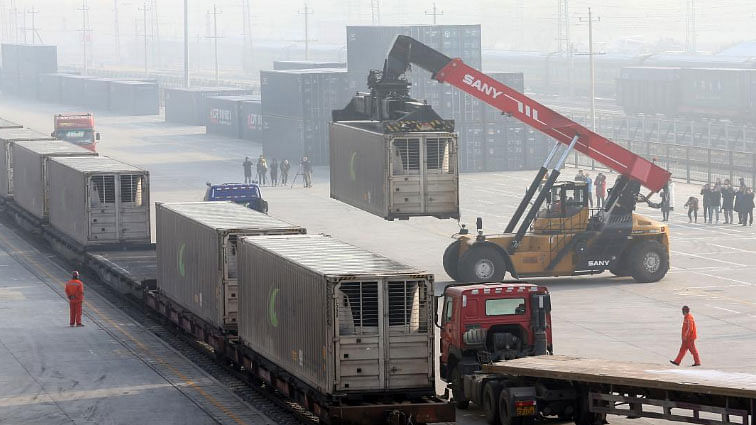 Workers unload containers from a train at Dahongmen Railway Station in Beijing, China on 14 January 2019. -- Photo: China Daily via Reuters