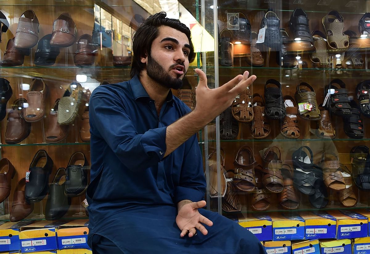 In this picture taken on 29 September 2018 Afghan refugee Shahzad Alam speaks during an interview with AFP at his shoe shop in the historic Qissa Khawani bazaar in Peshawar. Photo: AFP