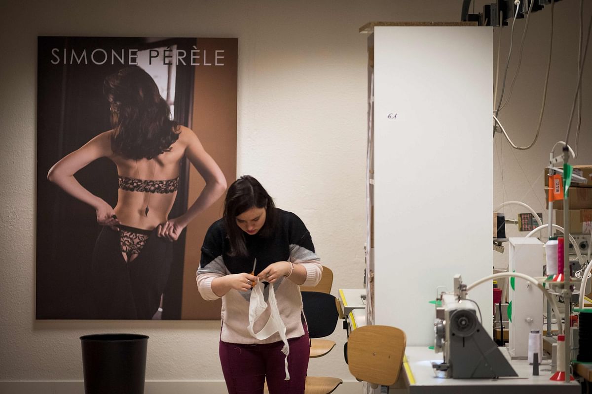 A seamstress works at the Simone Perele lingerie company headquarters in Clichy, outside Paris, on 20 December 2018. Photo: AFP