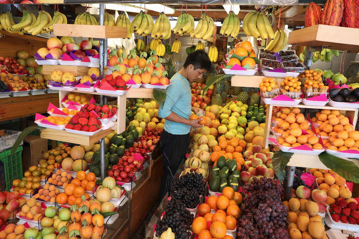 A vendor selects fruit for sale at a market in Lima, Peru on 2 November 2018. Photo: Reuters