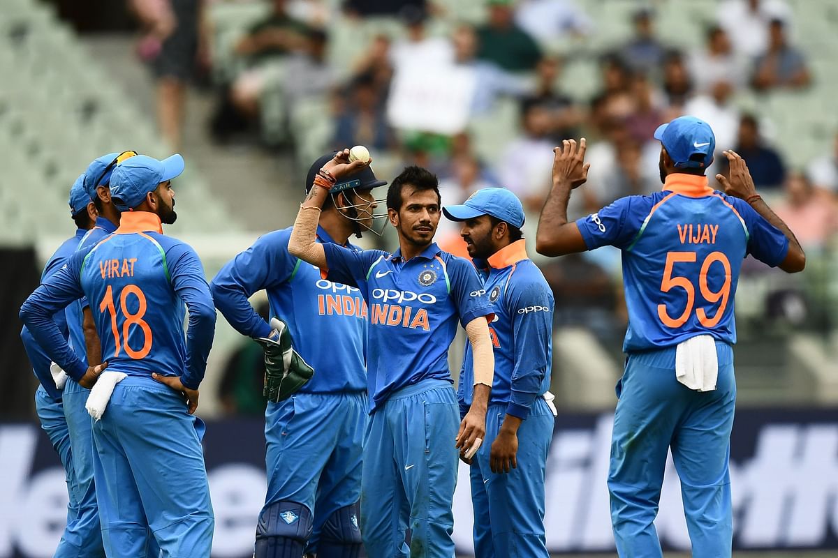 India`s Yuzvendra Chahal (C) celebrates with teammates after dismissing Australia`s Peter Handscomb during the third one-day international cricket match between Australia and India at the Melbourne Cricket Ground in Melbourne on 18 January 2019. Photo: AFP