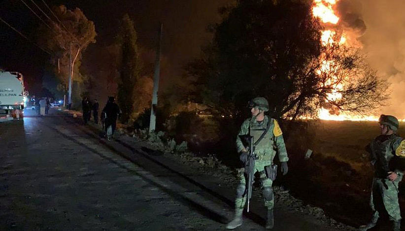 Military personnel watch as flames engulf an area after a ruptured fuel pipeline exploded, in the municipality of Tlahuelilpan, Hidalgo, Mexico, near the Tula refinery of state oil firm Petroleos Mexicanos (Pemex), on 18 January, 2019 in this handout photo provided by the National Defence Secretary (SEDENA). Photo: Reuters