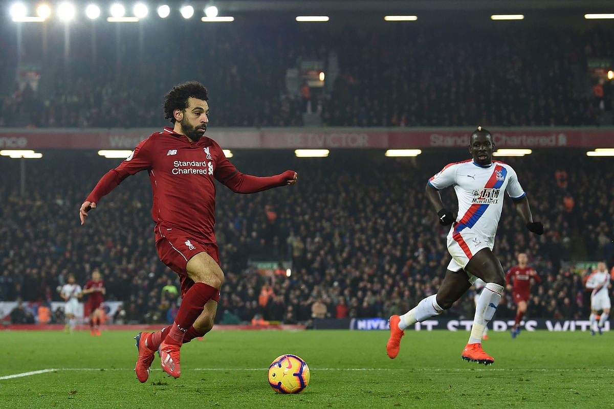 Liverpool`s Egyptian midfielder Mohamed Salah (L) runs with the ball during the English Premier League football match between Liverpool and Crystal Palace at Anfield in Liverpool, north west England on 19 January, 2019. Photo: AFP