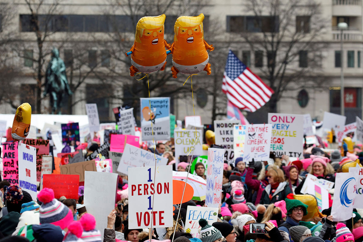 Baby Trump balloons float over thousands of people as they participate in the Third Annual Women`s March at Freedom Plaza in Washington, US, on 19 January. Photo: Reuters