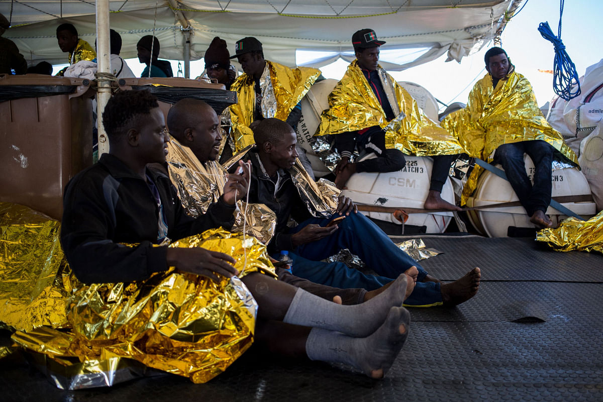 Migrants wrapped in survival blankets are pictured aboard the Dutch-flagged vessel Sea Watch 3 after being rescued from an inflatable boat, during a rescue operation off Libya`s coasts on 19 January 2019. Photo: AFP