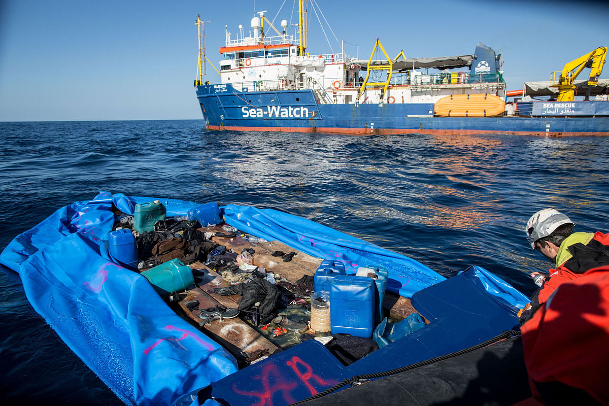 A Sea Watch 3 crew member marks with spray paint a rubber boat that the NGO destroyed after rescuing 47 migrants that were onboard, during a rescue operation by the Dutch-flagged vessel (Rear) off Libya`s coasts on 19 January 2019. Photo: AFP