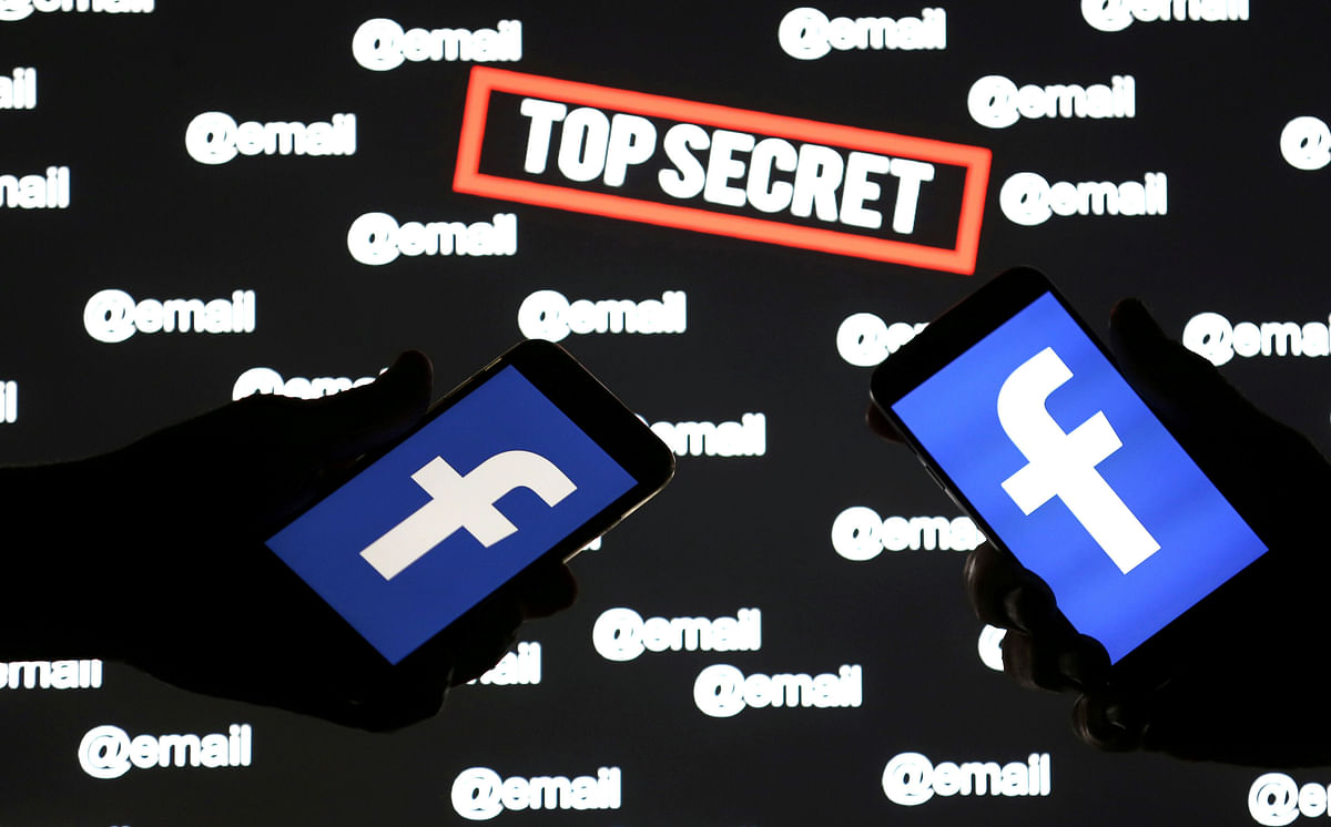 Persons hold smartphones with the Facebook logo in front of displayed `top secret` and `email` words in this picture illustration taken on 6 December 2018. Photo: Reuters