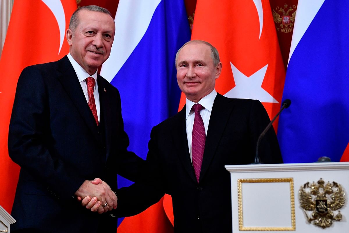 Russian President Vladimir Putin and his Turkish counterpart Recep Tayyip Erdogan shake hands at the end of a joint press conference following their meeting at the Kremlin in Moscow on 23 January 2019. Photo: AFP