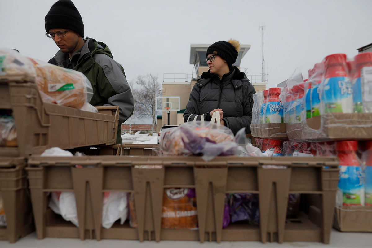 Karale Young, the wife of a member of the US Coast Guard working without pay during the government shutdown, picks up produce, eggs, milk, bread and other supplies being distributed by Gather food pantry at the US Coast Guard Portsmouth Harbour base in New Castle, New Hampshire, US, on 23 January 2019. Reuters File Photo