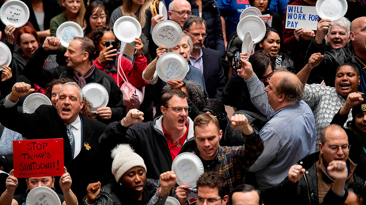 Federal employees holding empty plates stage a rally to call for a vote on the shutdown on Capitol Hill in Washington, DC, on 23 January 2019. Photo: AFP